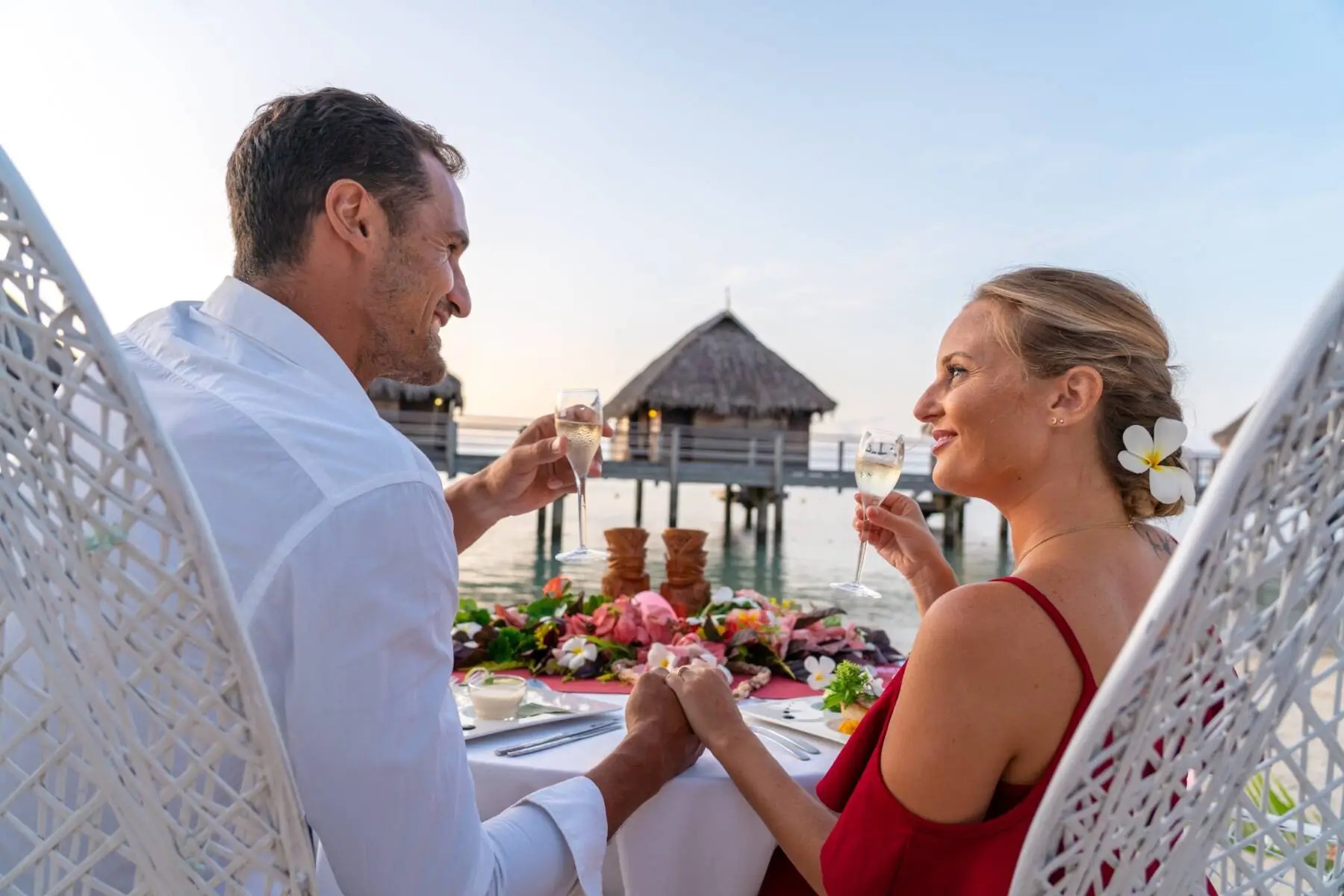 Couple relaxing on a tropical overwater deck