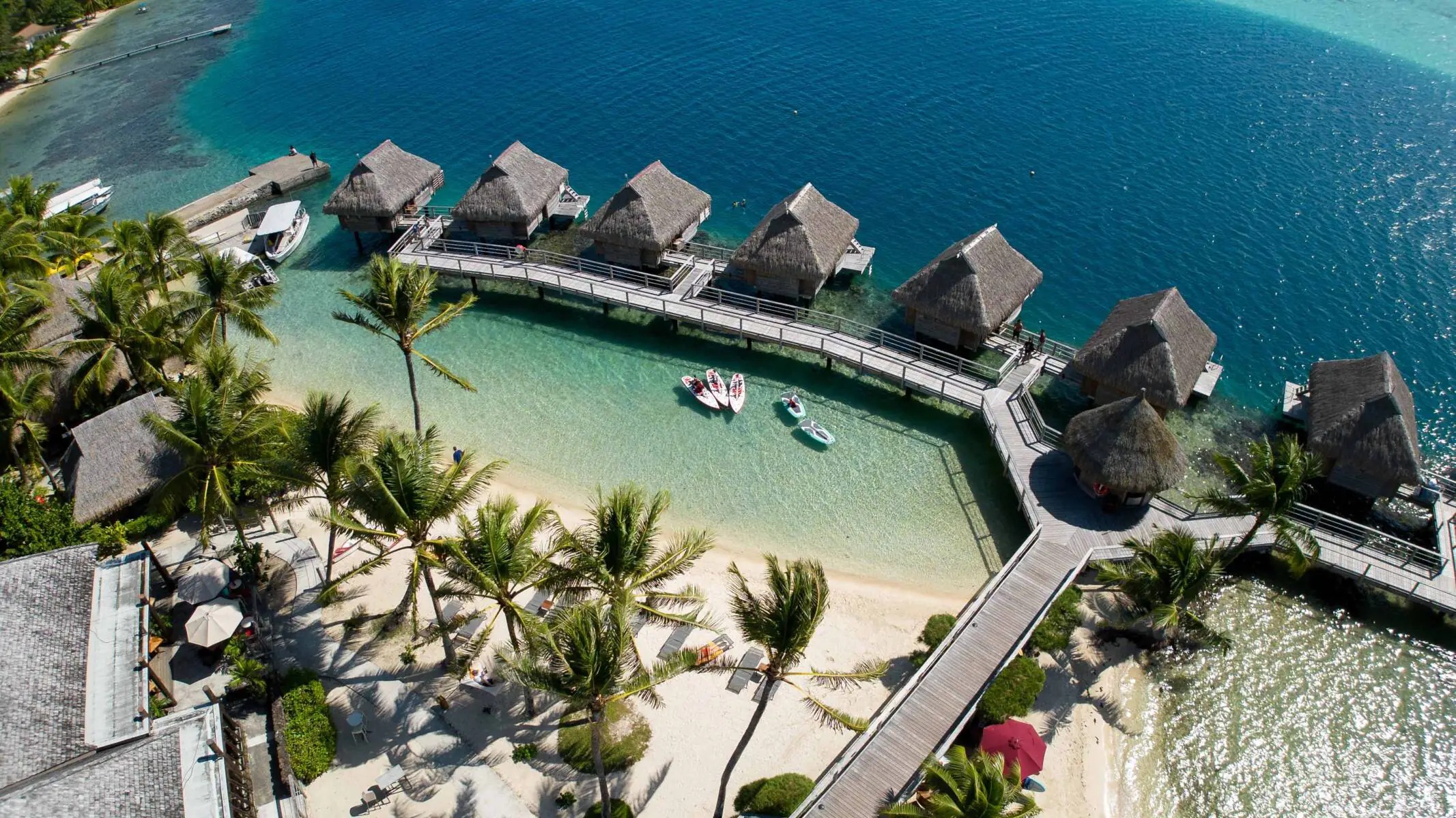 Overwater bungalow above turquoise lagoon in French Polynesia